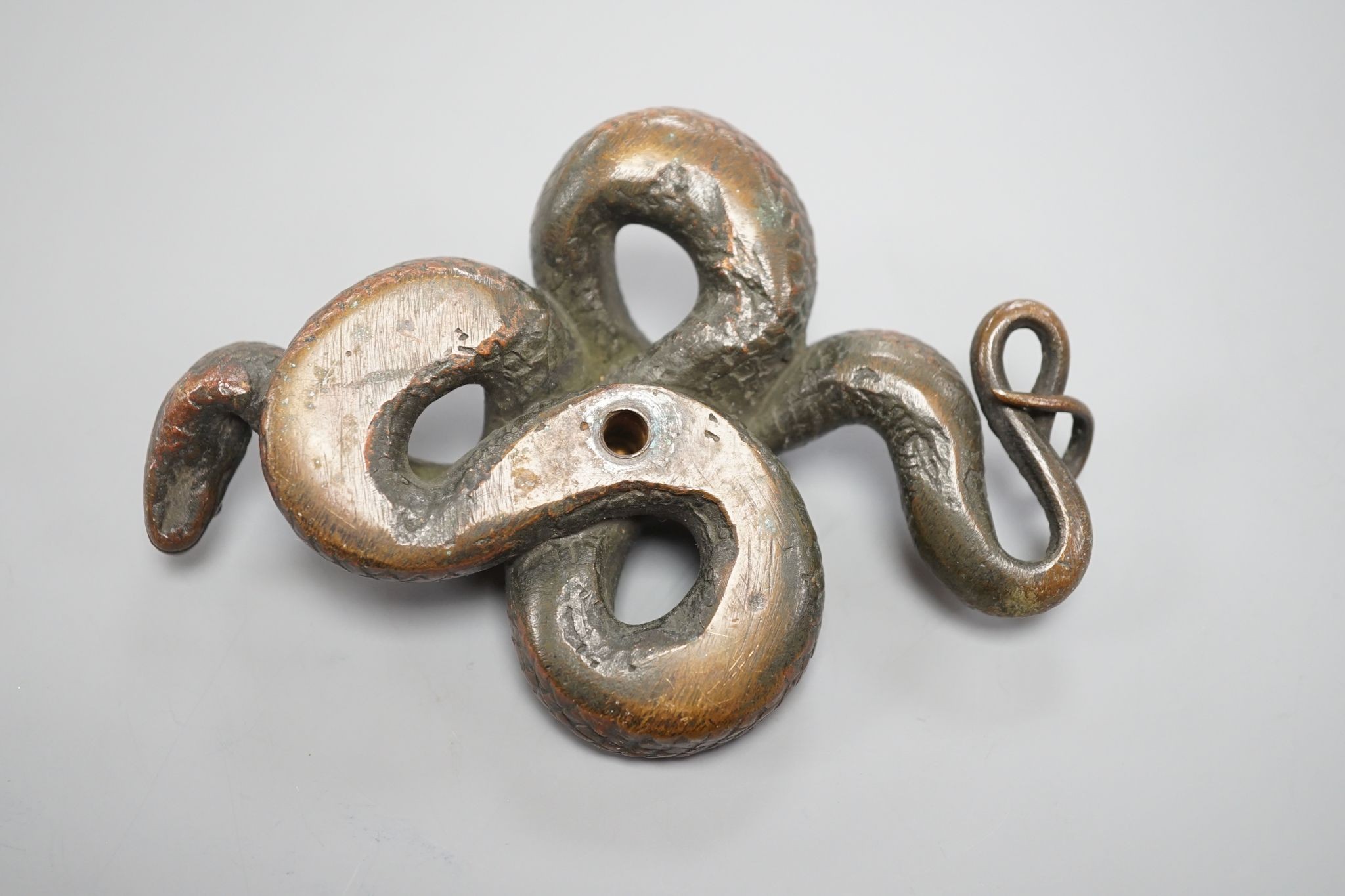 A European cast bronze figure of a snake, 12 cms wide.